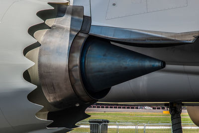 Close-up of airplane on airport runway against sky