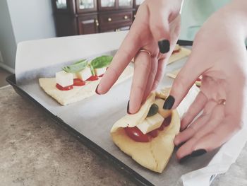 High angle view of woman eating food on cutting board