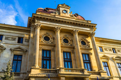 Low angle view of historical building against blue sky