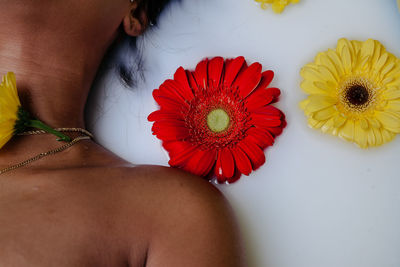 Midsection of woman with flower