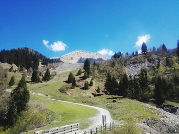 Scenic view of mountains against blue sky