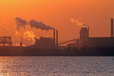 Silhouette of built structure at sunset