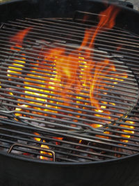 Close-up of yellow fire on barbecue grill