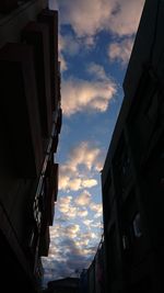 Low angle view of building against cloudy sky