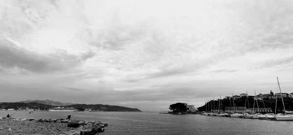 View of marina bay against cloudy sky