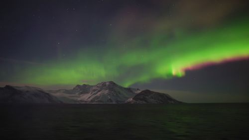 Scenic view of mountains against sky at night