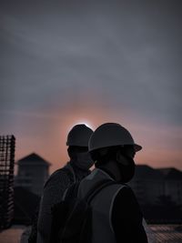 Rear view of man standing against sky during sunset