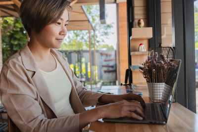 Woman using laptop at cafe