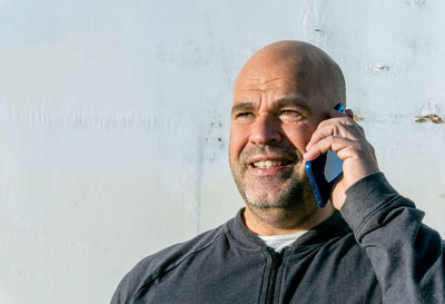 Portraiot of middle aged man talking with phone.