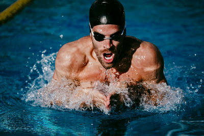 Portrait of man swimming in pool