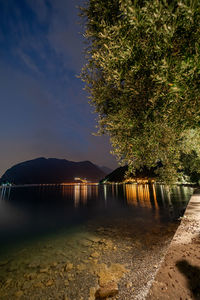 Scenic view of lake by mountain against sky