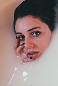 Close-up portrait of woman taking milk bath