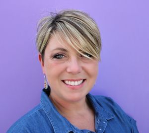 Portrait of smiling woman against blue background