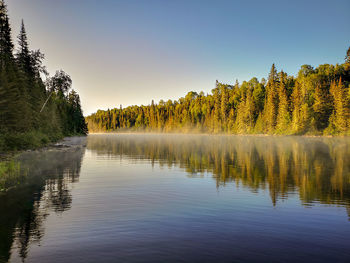 Scenic view of lake against sky at sunset