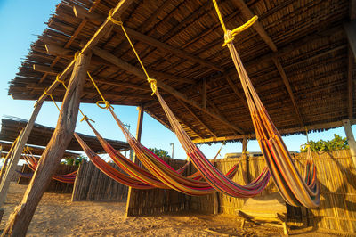Low angle view of hammocks under thatched roof