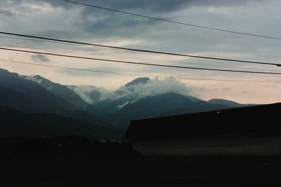 Scenic view of mountains against cloudy sky