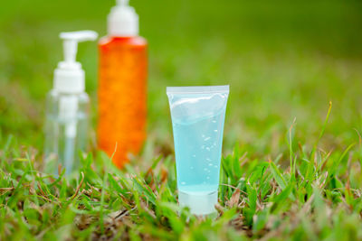 Close-up of green bottle on field