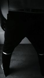 Close-up of woman standing on tiled floor