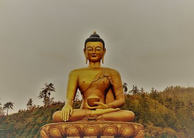 Low angle view of statue against sky