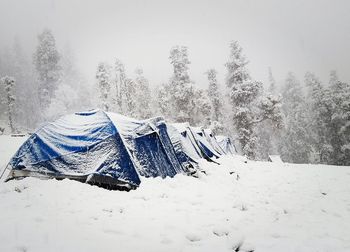 Scenic view of snow covered field against sky