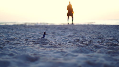 Man on beach during sunset