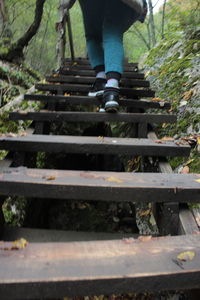 Low section of person walking on railroad track