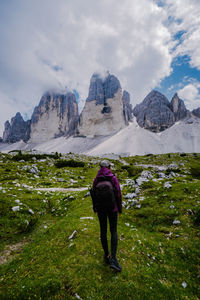 Rear view of woman on field against sky