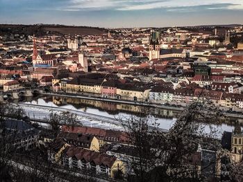 Aerial view of river in town against sky