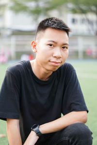 Portrait of young man sitting outdoors