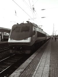 Train at railroad station against sky