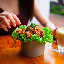 Midsection of woman holding potted plant