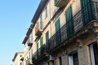 Low angle view of old building against clear blue sky