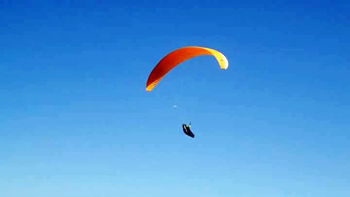 mid-air, parachute, paragliding, adventure, extreme sports, flying, sport, leisure activity, exhilaration, transportation, low angle view, blue, clear sky, hot air balloon, unrecognizable person, parachuting, freedom, lifestyles