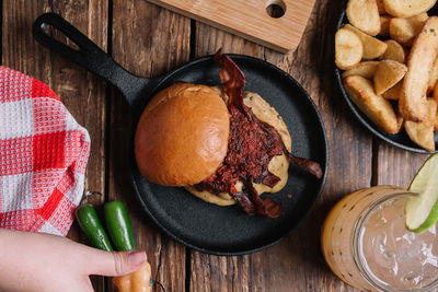 High angle view of hand holding bread on table