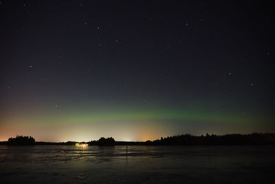 Scenic view of lake against sky at night