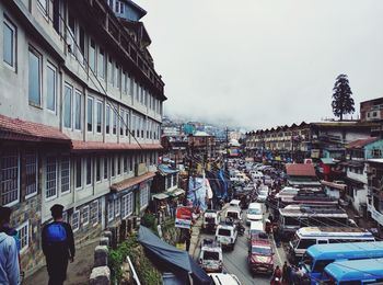 Vehicles on road along built structures