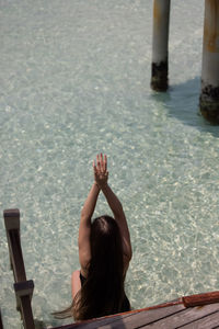 High angle view of woman sitting at beach