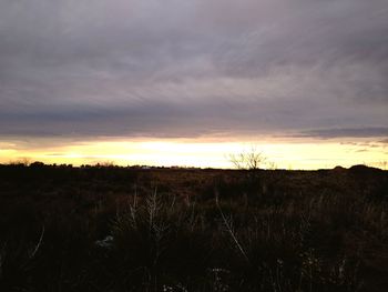 Silhouette landscape against sky during sunset