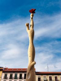 Low angle view of statue against blue sky