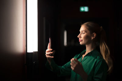 Side view of woman using mobile phone