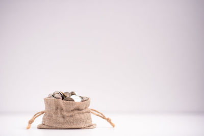 Close-up of bread on table against white background