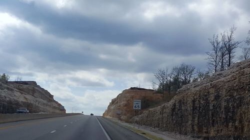 View of road against cloudy sky