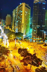 High angle view of illuminated city street and buildings at night