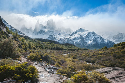 Scenic view of mountains against cloudy sky