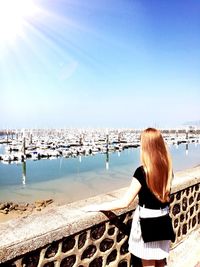 Rear view of woman looking at sea against sky