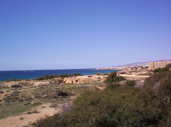 Scenic view of beach against clear blue sky