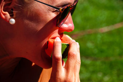 Close-up of woman eating watermelon