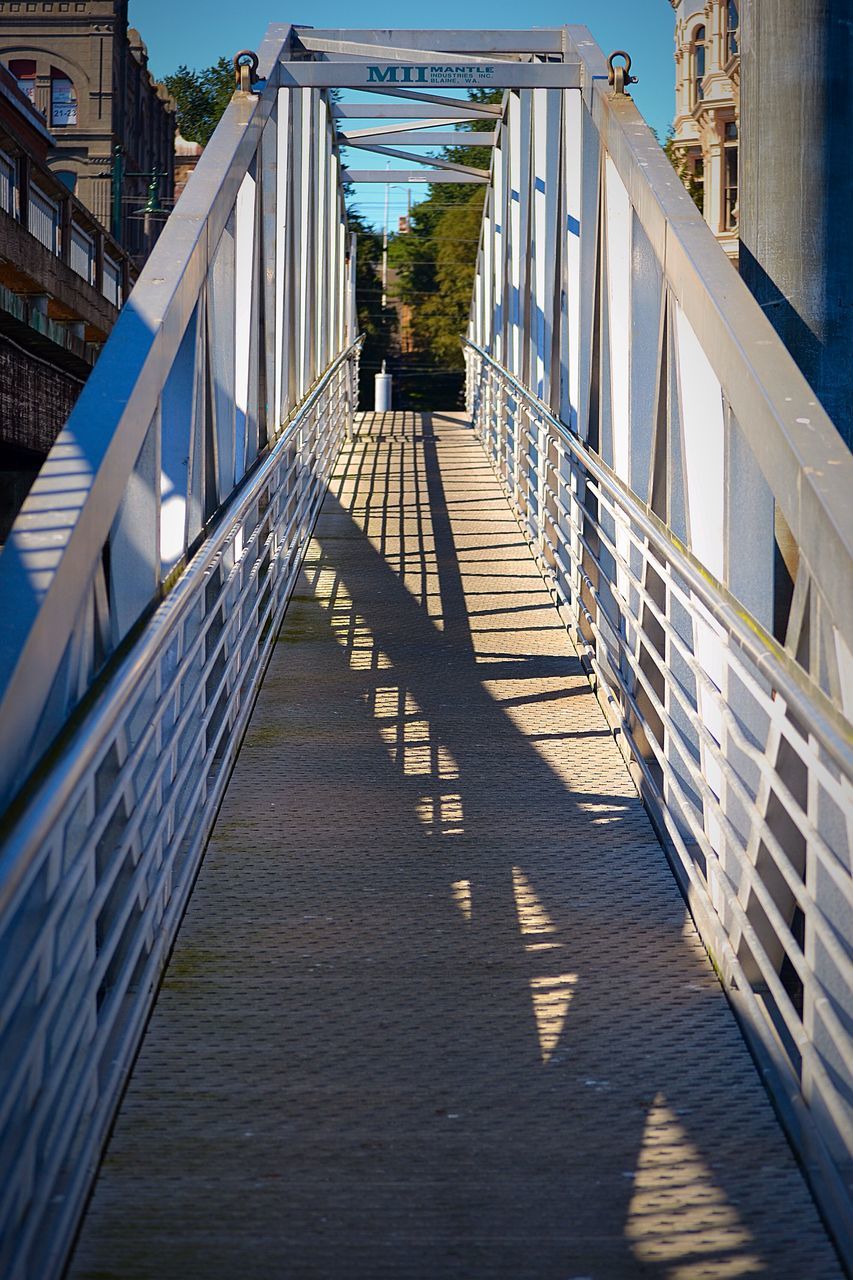 architecture, built structure, building exterior, the way forward, city, diminishing perspective, building, shadow, sunlight, railing, low angle view, residential structure, residential building, vanishing point, day, narrow, outdoors, no people, sky, steps