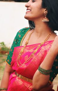 Portrait of young woman standing outdoors