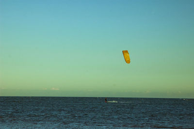 Man windsurfing on sea 